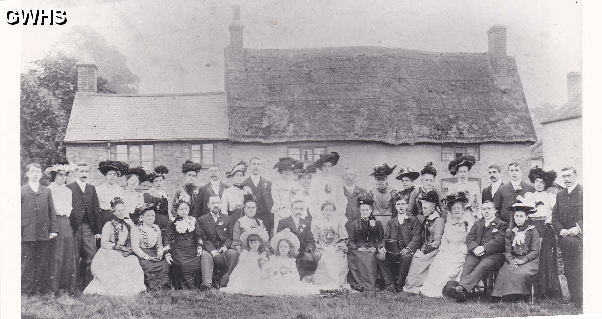 8-72 Butcher Johnsons fathers wedding outside old cottages on Bull Head Street Wigston Magna