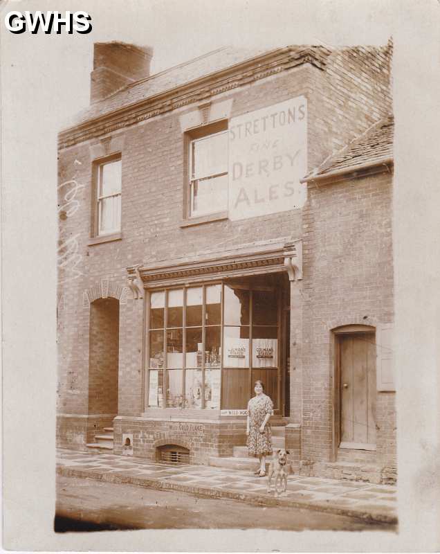 29-642 18 Bushloe End Wigston Magna Emma Bates nee Holt outside her shop c 1940