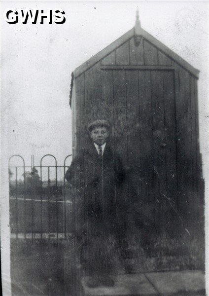 33-758 Walter Woodward outside a small hut either in the Park off Blaby Road or at the open air swimming baths near the canal next to Bush Lock 1928
