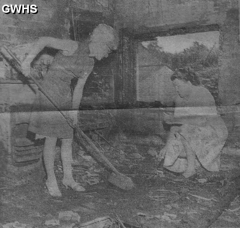 23-801 Penny Hallam and Mary Moss clearing up after the fire in June 1964