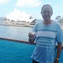 34-582 Ron Chapman on balcony of Diamond Princess cruise ship with Sydney Opera House in background. Feb March 2018